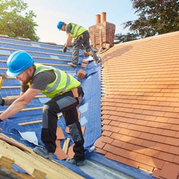 Roofers at work on a home roof