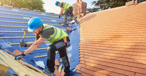 Roofers at work on a home roof