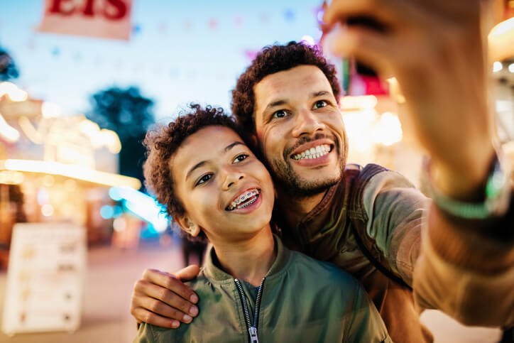 Father takes selfie with his son who has braces