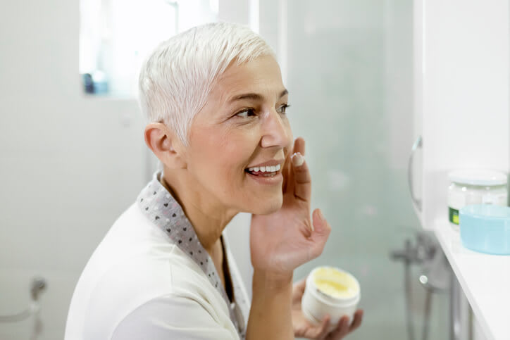 Woman applies acne cream