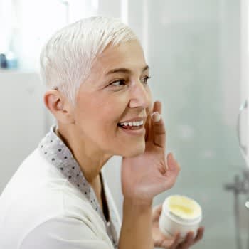 Woman applies acne cream