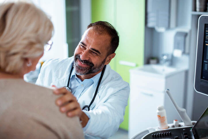 Doctor smiles and talks with patient