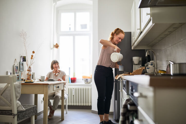 Caregiver makes coffee for her patient