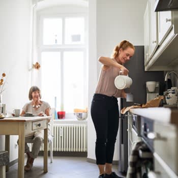 Caregiver makes coffee for her patient