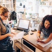 Two small business owners reviewing finances