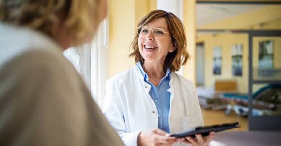 Doctor smiles while reviewing information with her patient