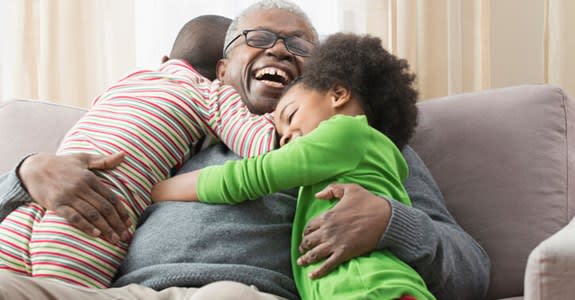 Smiling grandfather with young grandchildren