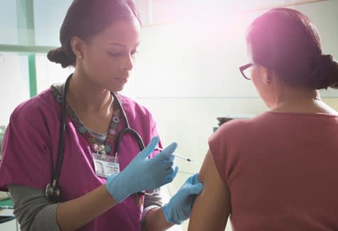 Nurse gives medication shot to patient