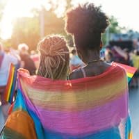 Couple embraces during Pride parade