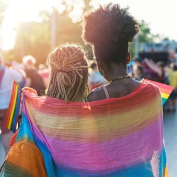 Couple embraces during Pride parade