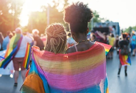 Couple embraces during Pride parade