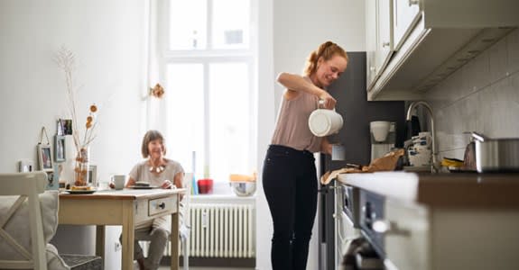 Caregiver makes coffee for her patient