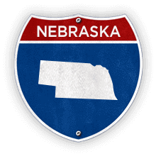 Road sign with Nebraska text and state outline.