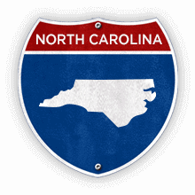 Road sign with North Carolina text and state outline.