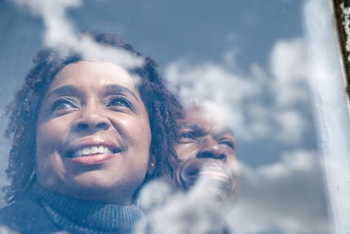 Couple looking out of window