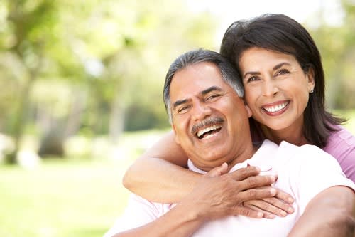 Smiling couple outside on a sunny day