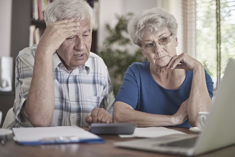 Senior couple concerned while calculating finances