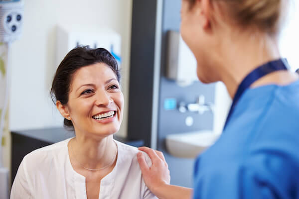 Woman smiles at her doctor while in the doctor office