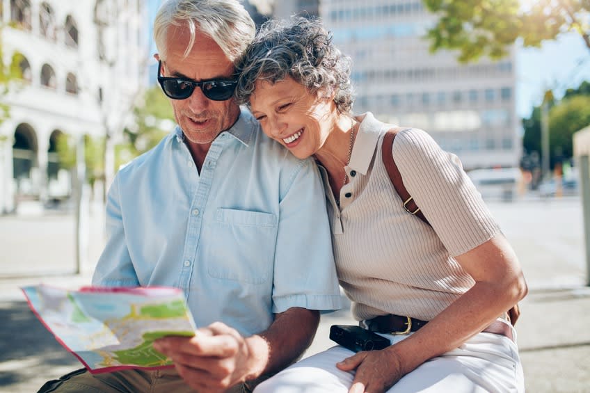 Senior couple examines map