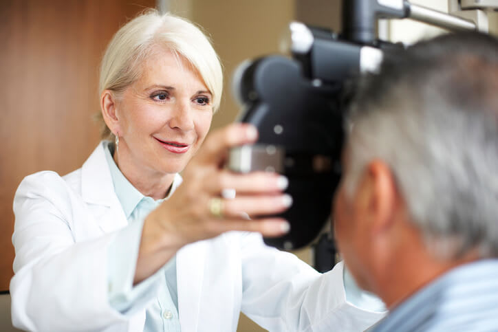 An eye doctor gives a patient an eye exam