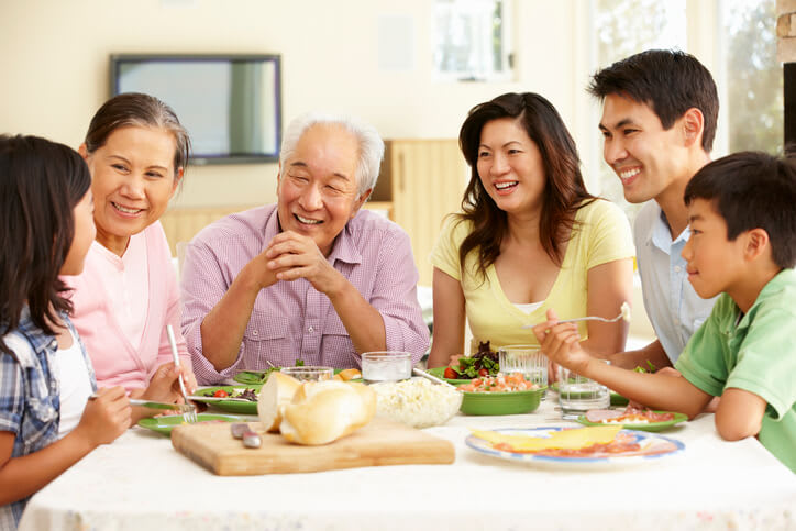 Several generations of family share a meal at home
