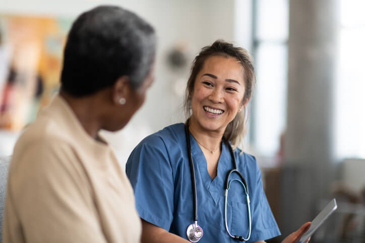 Doctor smiles as she speaks with her patient