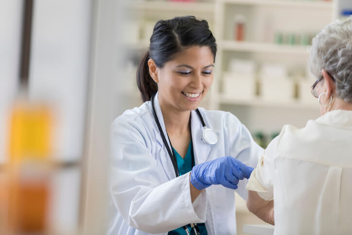A doctor gives her patient a vaccination