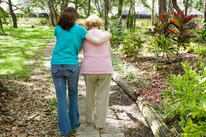 Daughter walking with elderly mother