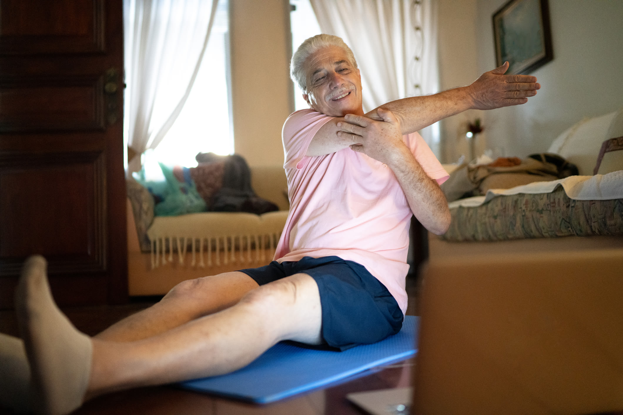 Older Man Exercising At Home (1)