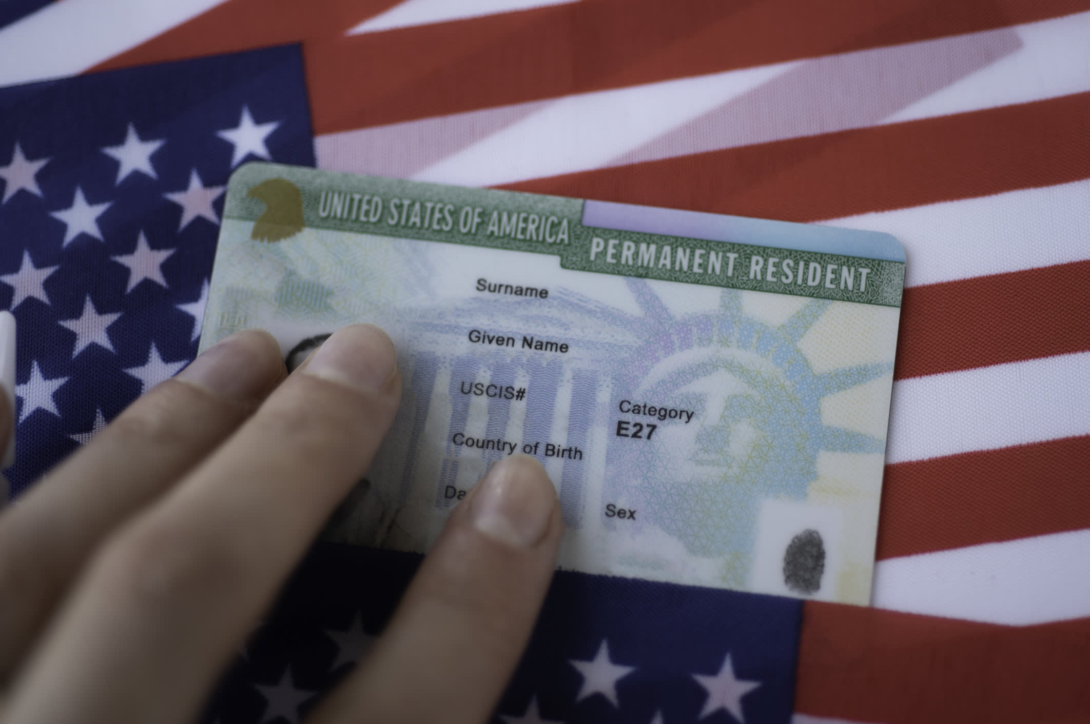 Permanent Resident Green Card Of United States Of America On Flag Of USA
