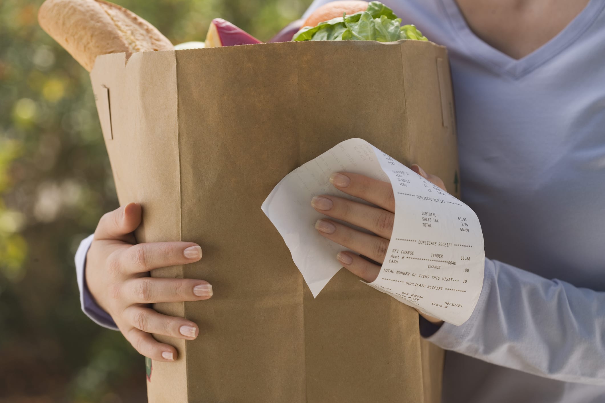 Woman Holding Grocery Bag And Receipt