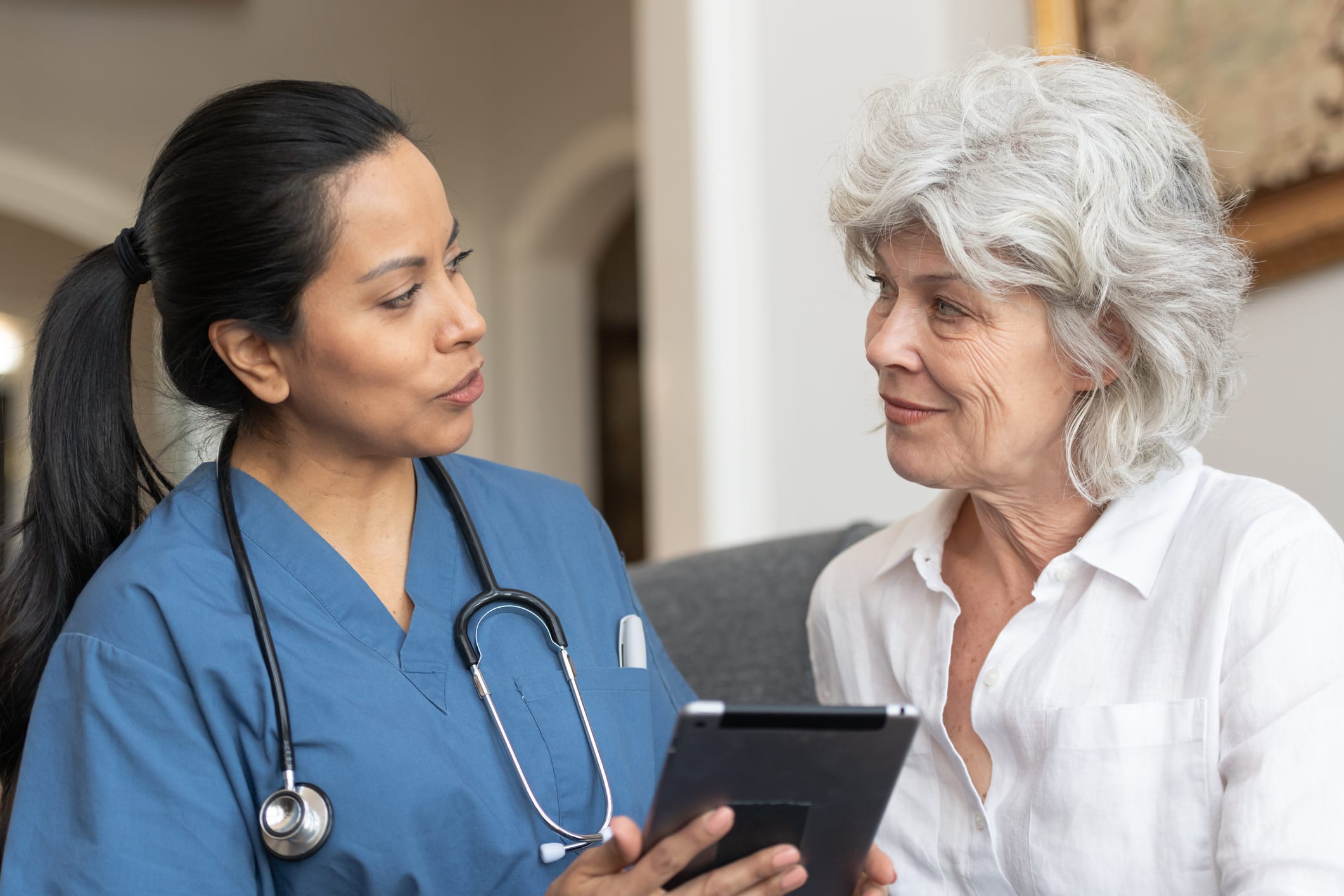 Doctor With Patient At Home