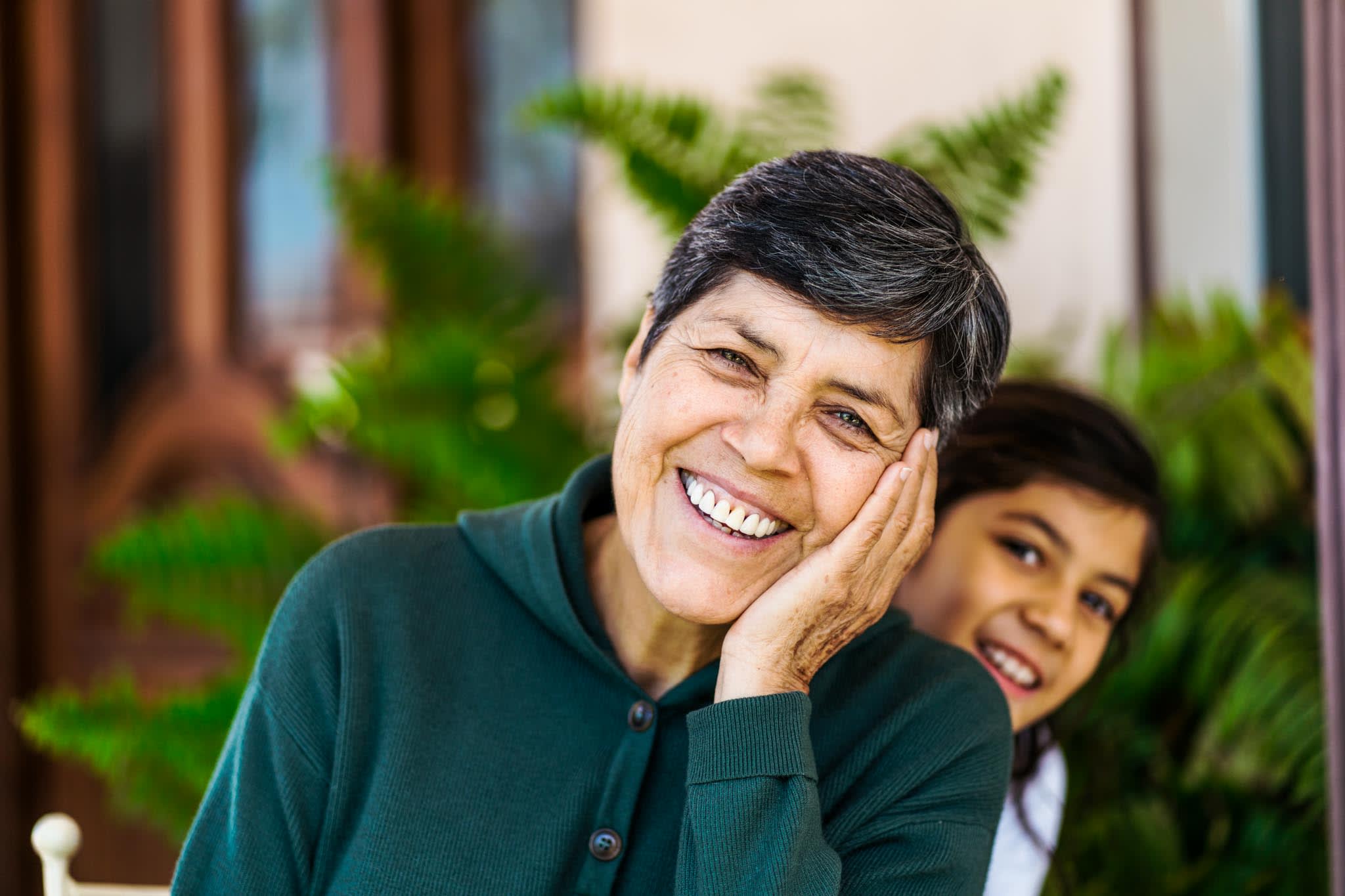 Grandmother Nad Granddaughter Smiling In Patio