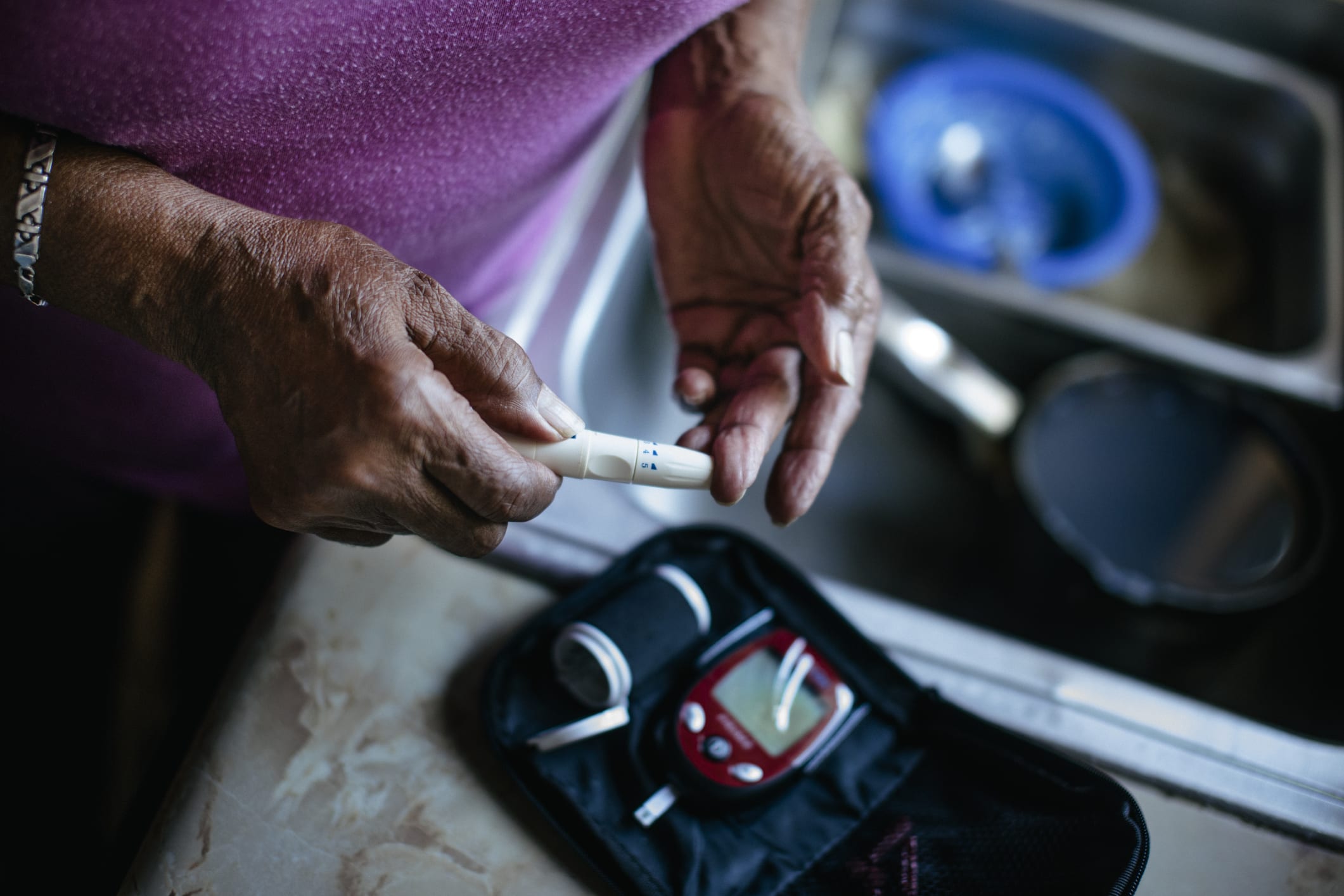 Senior Woman Checking Blood Sugar Levels