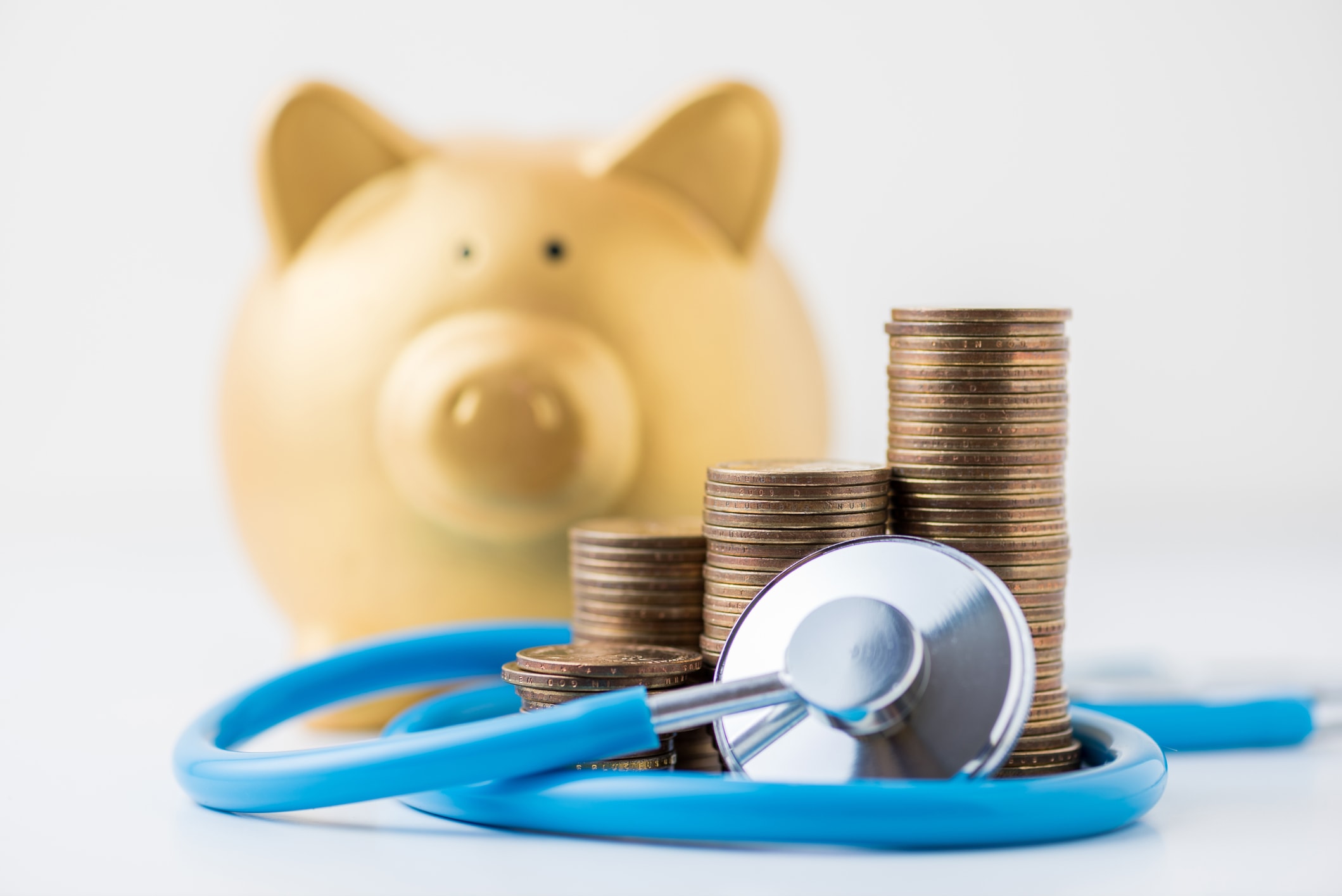 Piggybank With Coins And Stethoscope