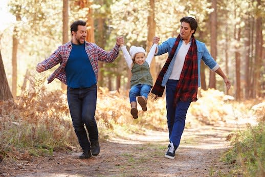 Male couple playing with young daughter