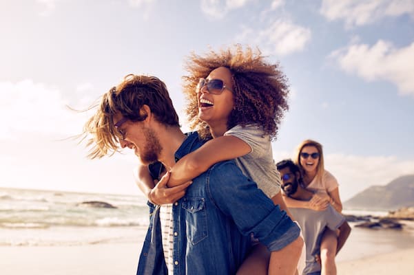 Playful young couples on the beach