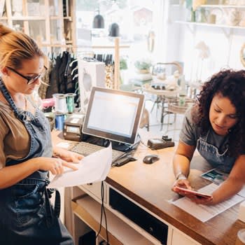 Two small business owners reviewing finances