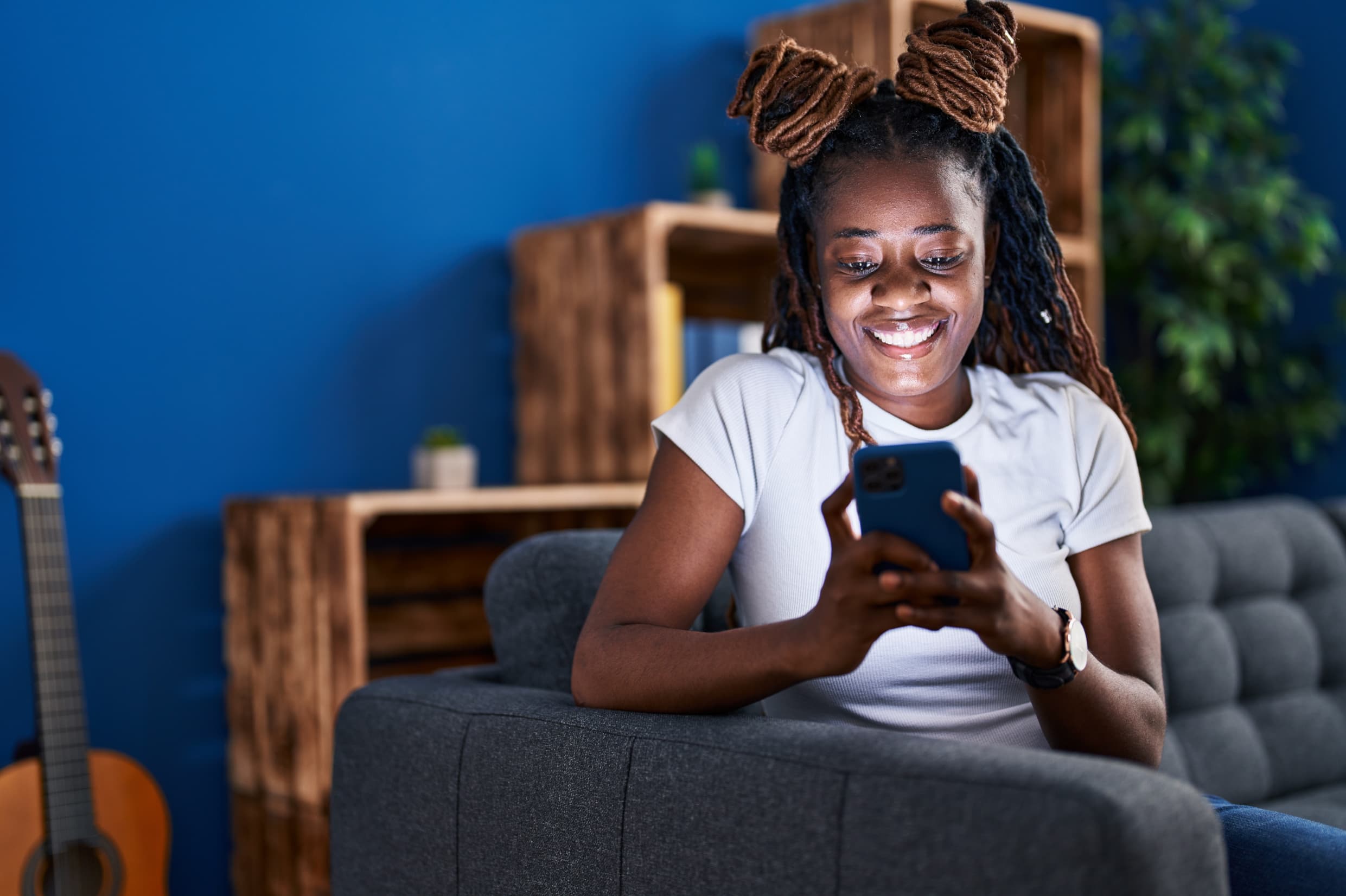 Happy young solo traveller using travelbeta mobile app to find the cheap flights because its cheaper on travelbeta.com - Book cheap flights to Lagos on travelbeta website - Book cheap flights from Nigeria - Book cheap flights from Nigeria - Pay small small - Travelbeta installment plan TIP