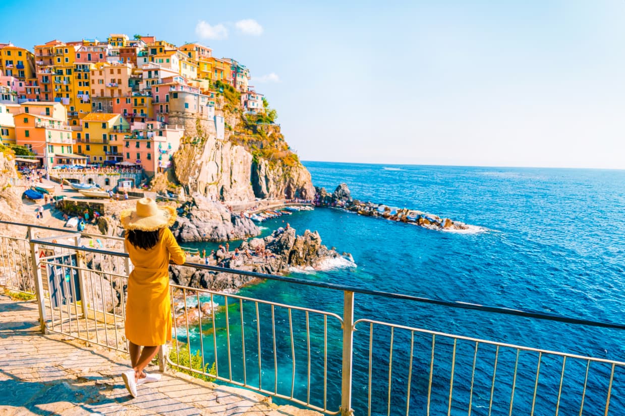 Tourist enjoying amazing sea views in Cinque Terre, Italy - Best places to visit in Europe