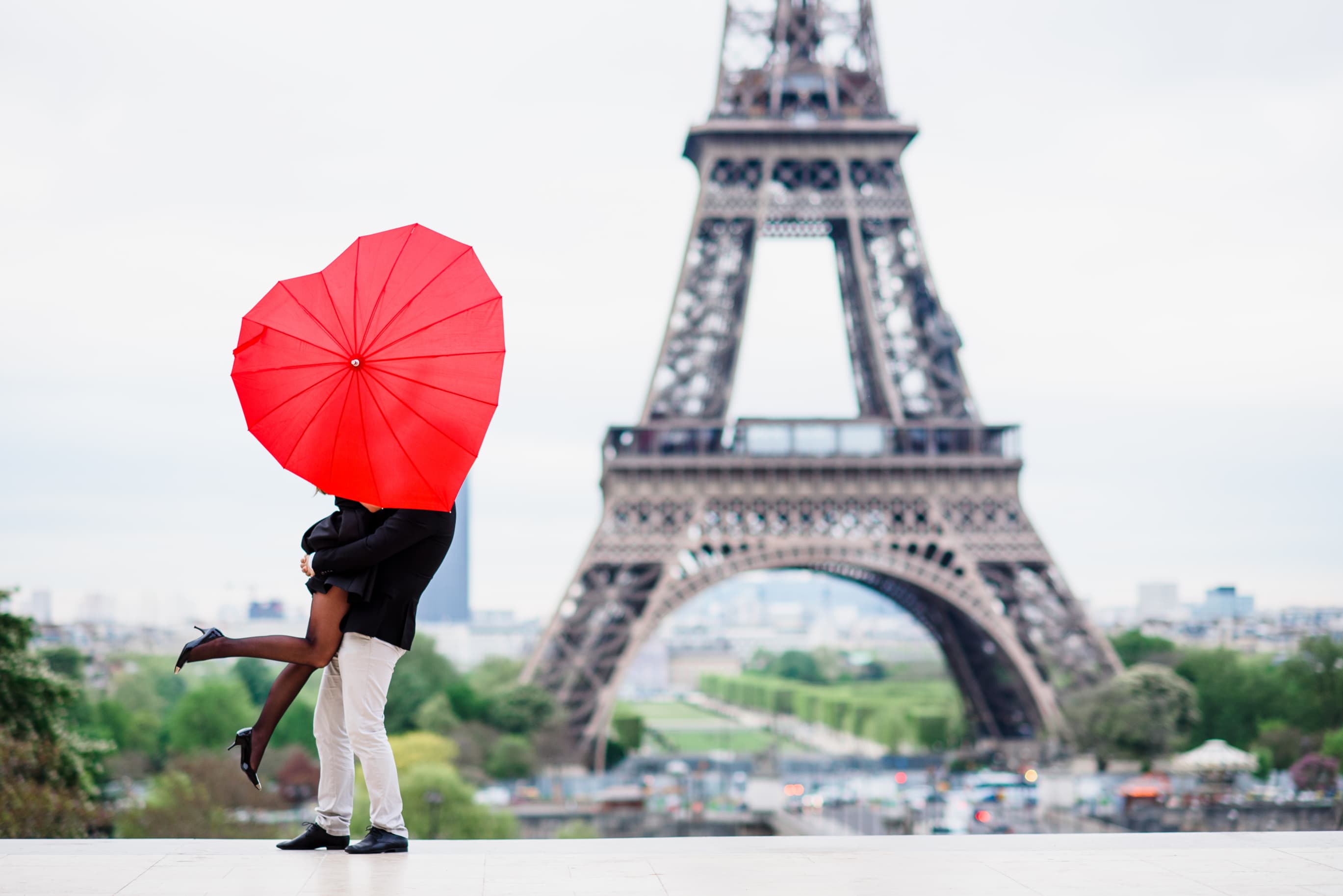 Couples in Paris close to world-famous spot, the Eiffel Tower - Best places to visit in Europe