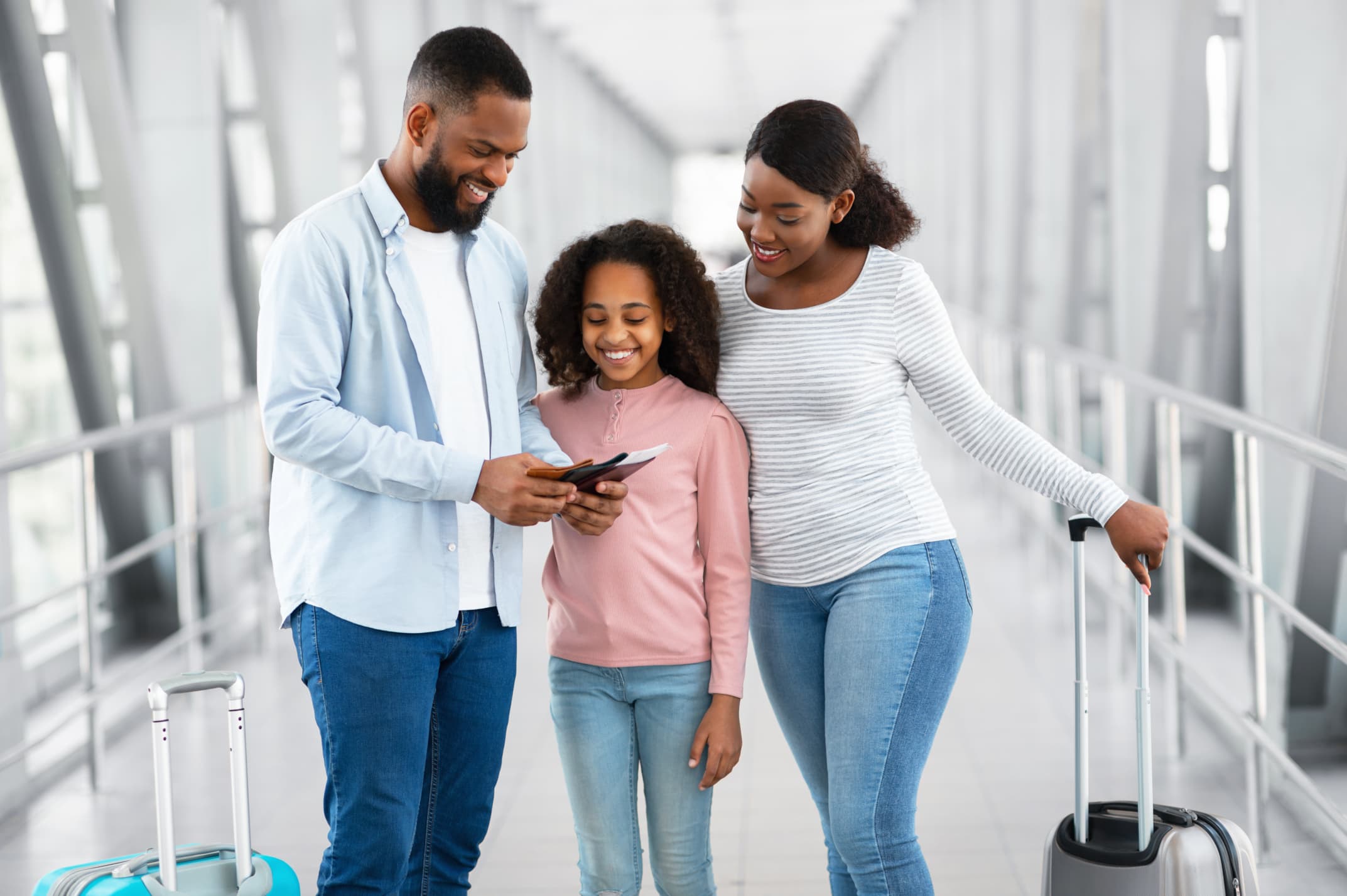Family of three holding and looking at their Passports with Boarding Passes, checking how long it is valid - 7 INTERNATIONAL TRAVEL FACTS: A Simple Guide to a Smooth Trip - International Travel Tips - Travel facts