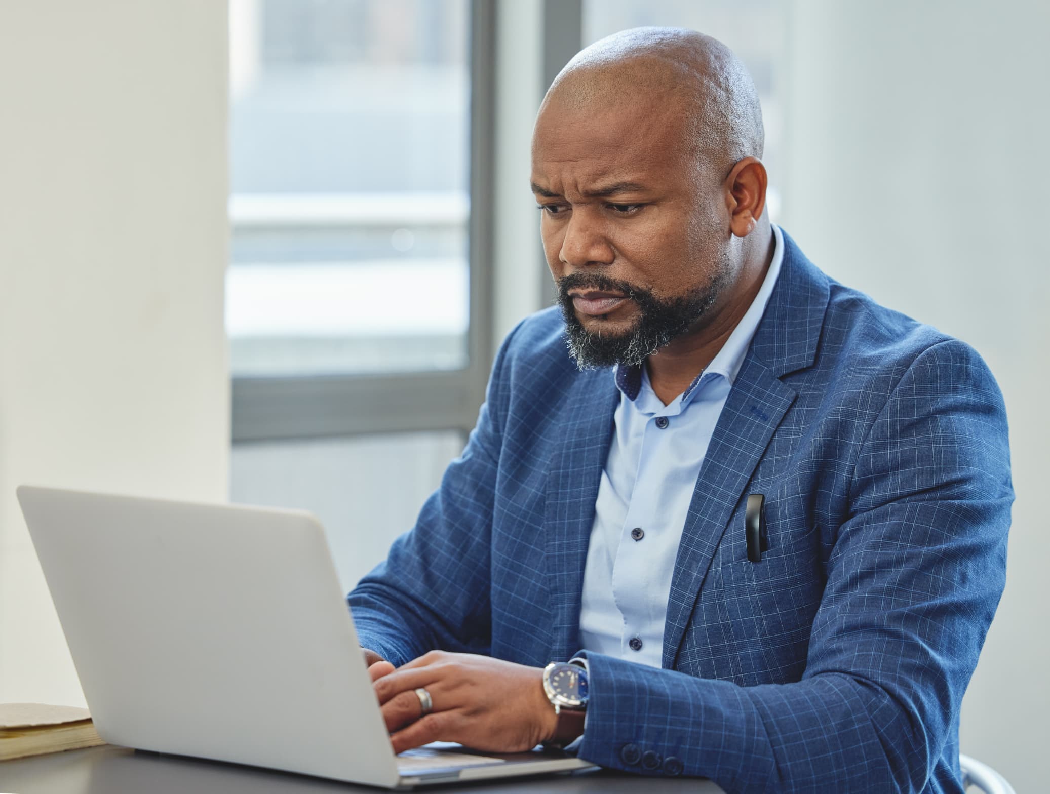 Man using laptop computer to make research before his international trip - 7 INTERNATIONAL TRAVEL FACTS: A Simple Guide to a Smooth Trip - International Travel Tips - Travel facts