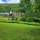 Thumbnail: Outside the grounds at Menla with lush green grass and a tree.
