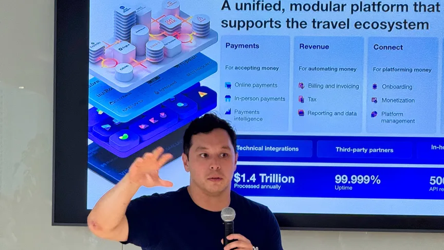 Jason Thong from Stripe giving a presentation to an audience with a screen behind him showing a presentation