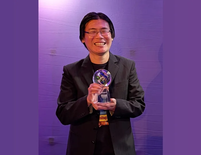 Raymond Cua holding Confluence Award after winning Best Food Creator in Canada