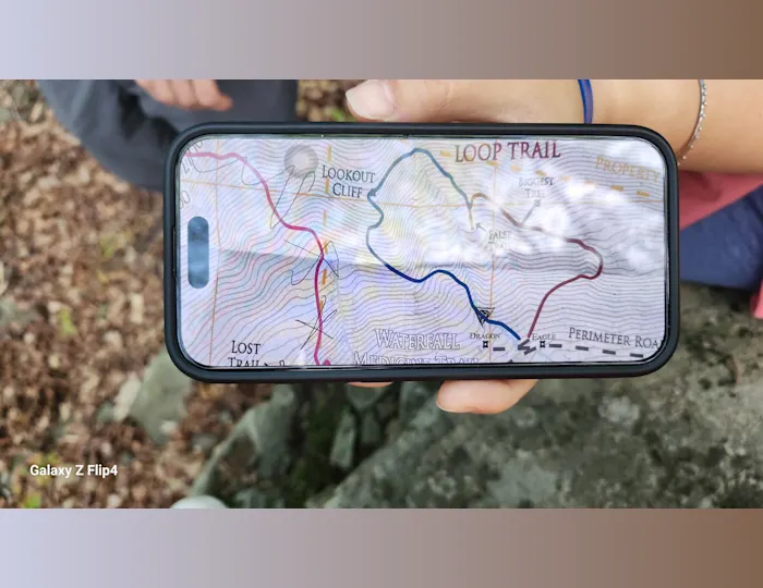The hiking trail map displayed on a phone showing countours and a loop trail