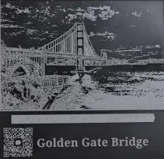 A tactile photo of the Golden Gate Bridge, featuring a QR code that scannable tactile QR code that provides a detailed audio description of the image.