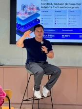 Jason Thong from Stripe giving a presentation to an audience with a screen behind him showing a presentation