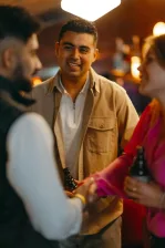 People socialising and shaking hands in a bar